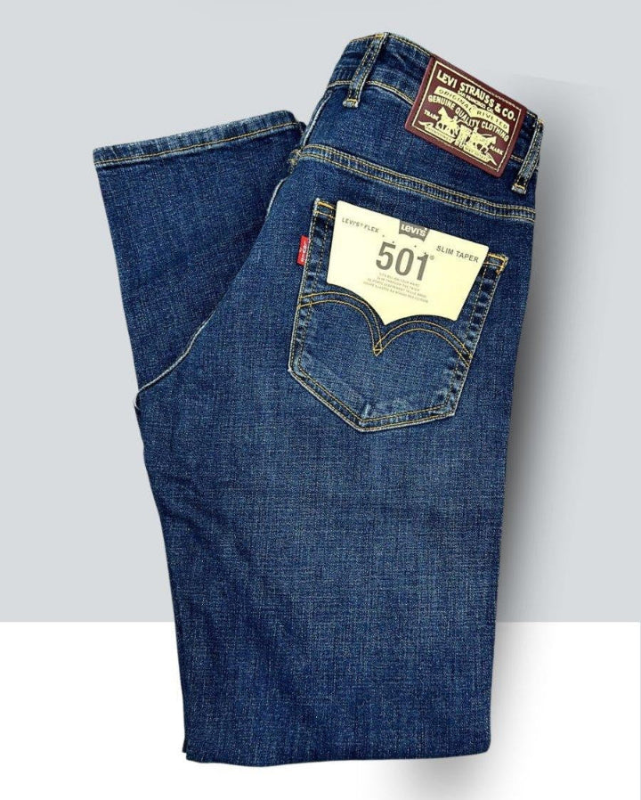 Folded pair of blue jeans with Levi's branding on a light gray background